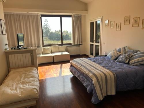 a bedroom with a bed and a couch in it at Villa del Sole in Valverde
