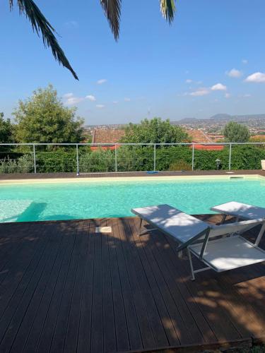 a swimming pool with two lounge chairs on a deck at Villa del Sole in Valverde