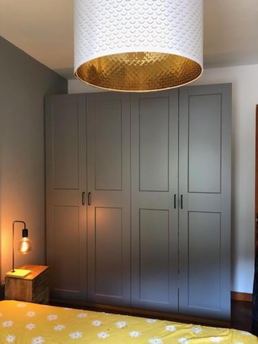 a bedroom with a bed and a chandelier at Scanno Parco naz Abruzzo Nuovo Appartamento I Gerani,300 m dal centro, vista, wifi garage max 7 persone in Scanno