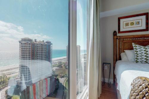 a bedroom with a large window with a view of the ocean at Portofino 2-1906 in Pensacola Beach