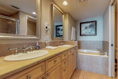 a bathroom with two sinks and a tub at Portofino 2-1906 in Pensacola Beach