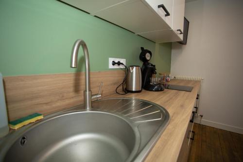 a kitchen counter with a sink in a kitchen at Fresh&Relax in Chamalières