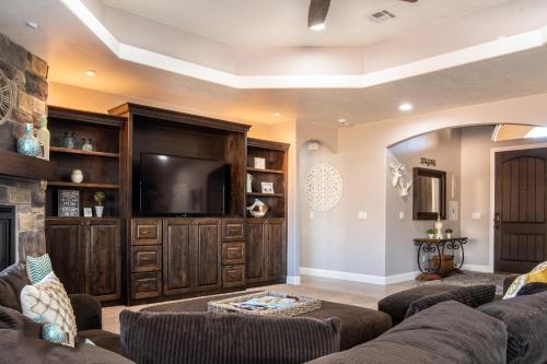 a living room with a couch and a tv at Sand Hollow 3334 BBQ Grill, Private Splash Pad, Hot tub and Pool in Hurricane
