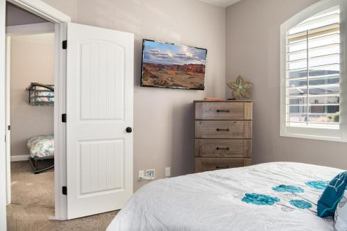 a bedroom with a bed and a window and a dresser at Sand Hollow 3334 BBQ Grill, Private Splash Pad, Hot tub and Pool in Hurricane