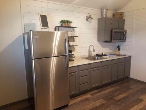a kitchen with a stainless steel refrigerator and a sink at Lakefront Cabin - The Willows - 11 in Mead