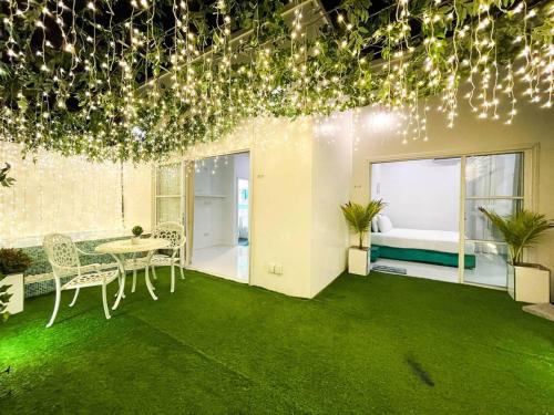 a room with a table and chairs and lights at Planktons Beach in Hulhumale