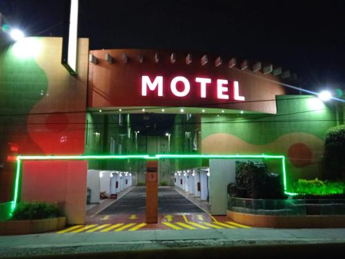 a motel with a neon sign at night at Hotel Florencia in Mexico City