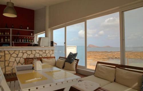 a living room with a white couch and a table at Murdeira Village V155A in Beirona