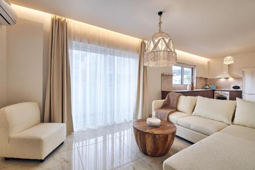 a living room with a couch and a table at Blush & Crema Apartments in Zakynthos Town