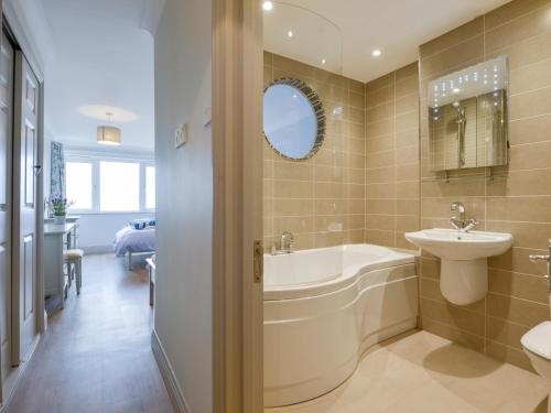 a bathroom with a tub and a sink and a toilet at 17 Burgh Island Causeway in Kingsbridge