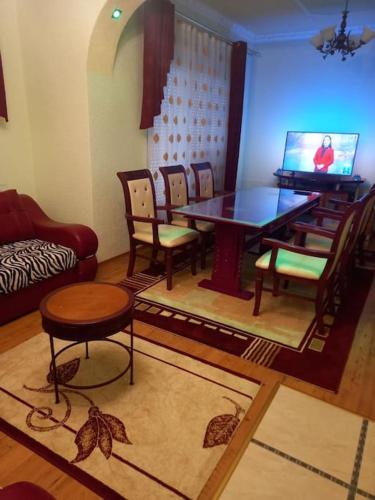 a living room with a dining room table and chairs at Vila Arapovi - Bosilovo in Strumica