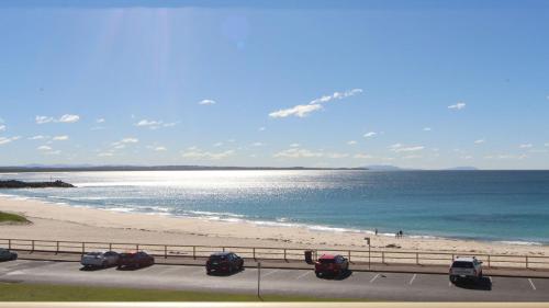 a view of the beach and the ocean from a highway at Ebbtide 13 in Forster