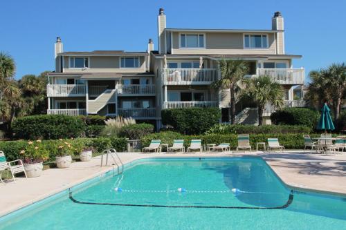 a house with a swimming pool in front of a house at Seagrove 5-A in Isle of Palms