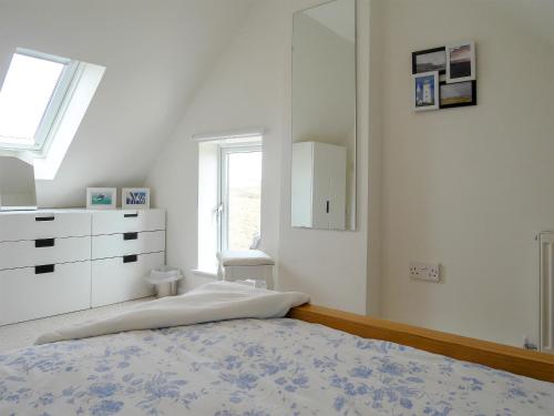 a bedroom with a bed and a dresser and a window at The Old Boathouse in Southwell