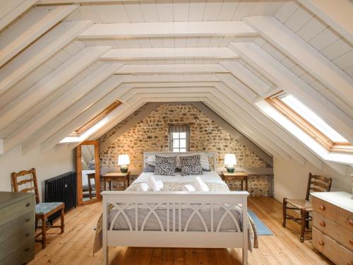 a bedroom with a white bed in the attic at Way's Forge in Dorchester