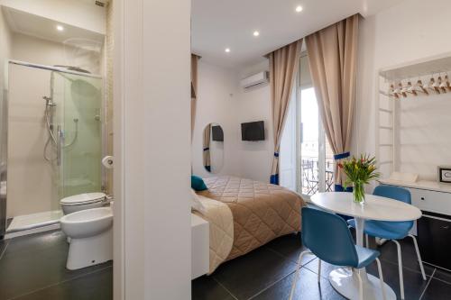 1 dormitorio con cama, mesa y baño en I Canestrari, en Nápoles