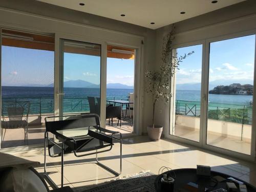 a living room with a view of the ocean at Golden Coast Panagias Apartment in Volos