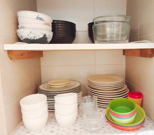 a shelf full of plates and bowls and dishes at Ocean 27 Batu Ferringhi Shamrock Beach 6 Bedroom 22pax with Pool in Batu Ferringhi
