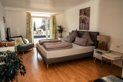 a living room with a bed and a couch at Wellnessoase Nordschwarzwald in Neuweiler