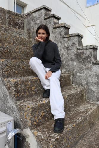 a woman is sitting on some stairs at Casa Mafalda in Aradeo