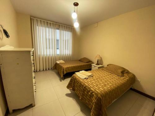 En eller flere senge i et værelse på Hermoso departamento de lujo - Zona Miraflores