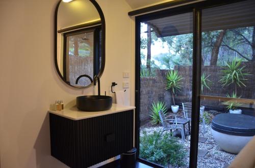 a bathroom with a sink and a mirror at Kudos Villas - Hepburn Springs in Hepburn Springs