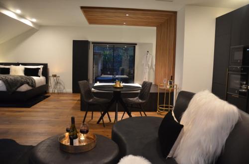 a living room with a bed and a couch and a table at Kudos Villas - Hepburn Springs in Hepburn Springs
