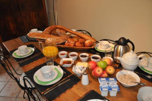 a table with a breakfast of food and fruit on it at Le Cep en Sancerrois in Sancerre