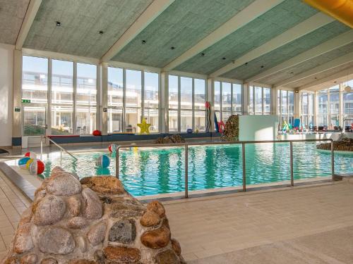 a large swimming pool in a building with windows at Apartment for 6 guests with loft, Ringkøbing in Ringkøbing