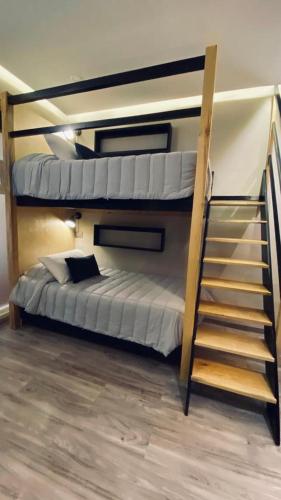 a bedroom with two bunk beds and a staircase at Carcamanes 17 Gastro-Hotel in Guanajuato