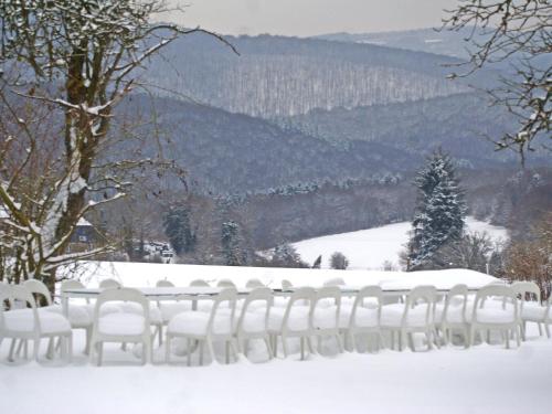 a row of white chairs in the snow at Mountain Retreat for Group in Daverdisse