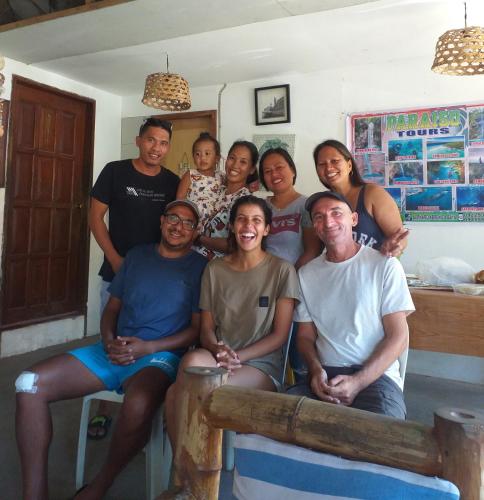 a group of people posing for a picture in a room at Paraiso Hostel Moalboal in Moalboal