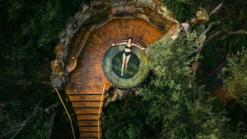 a woman in a bath tub in a sauna at Hamptons In Rye Studio - 3 Mins from Famous Hot Springs! in Rye