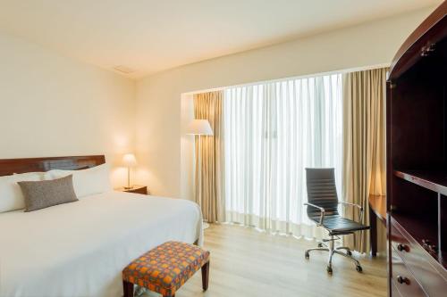 Una cama o camas en una habitación de Camino Real Pachuca