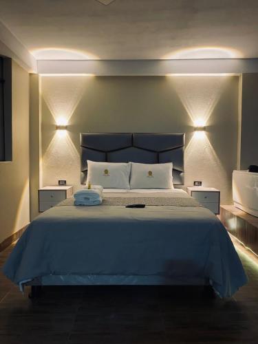 a bedroom with a large bed with lights on it at HOTEL MAR Y LAGO in Lunahuaná