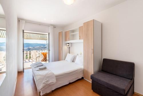 a bedroom with a bed and a chair at Apartments with parking space Lopar, Rab - 14070 in Lopar