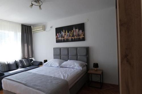 a bedroom with a bed and a couch at Apartments with WiFi Split - 20780 in Split