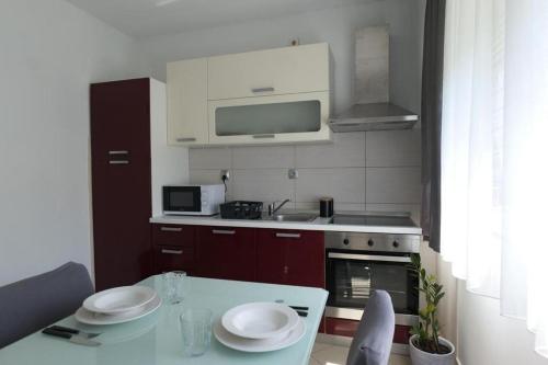 a kitchen with a table with two plates on it at Apartments with WiFi Split - 20780 in Split
