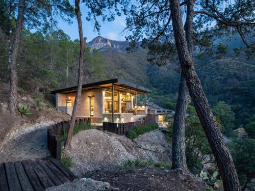a house in the woods with a view of a mountain at Vive Libre Travel Club in Santiago