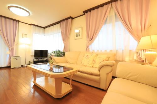 a living room with a couch and a table at RKT4bedroom ForFamily 30mins Shibuya and Azabu in Tokyo