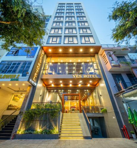 a building with stairs leading to the entrance to a v mas hotel at Yes Hotel Đà Nẵng in Danang