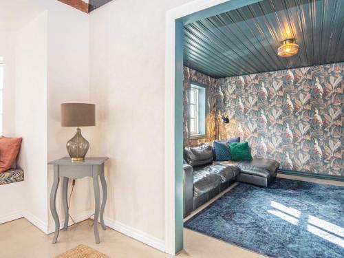 a living room with a leather couch and a table at 12 person holiday home in Sønder Omme-By Traum in Sønder Omme