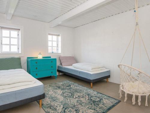 a room with two beds and a swing at 12 person holiday home in Sønder Omme-By Traum in Sønder Omme