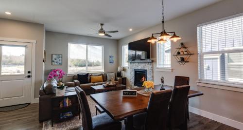 a dining room and living room with a table and a fireplace at Clam A Lot in Ocean Shores