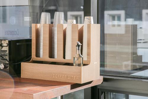 a wooden crate with a bottle of wine on a table at Rose Bay Hotel in Busan