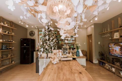 a large room with a table and a chandelier at Dahlia Dalat in Xuan An