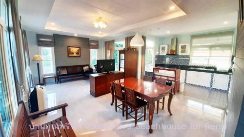 a dining room and living room with a table and chairs at Resort house - 2 min walk to the beach in Ban Krut