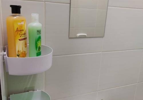 a bathroom with a bottle of mouthwash and a mirror at Homestay Asfa&Wazif in Arau