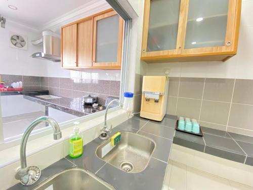 a kitchen with a sink and a counter top at Taman Saikat IPOH comfortable HomeStay 12 Pax in Ipoh