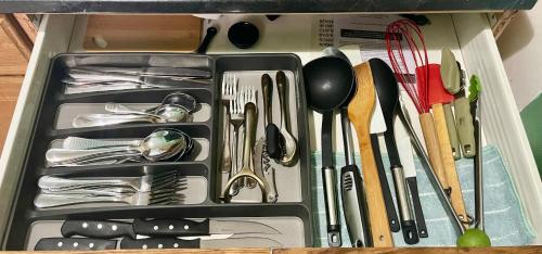 a drawer full of utensils in a container at 3 bedrooms 1 bath APT, 10 min to Manhattan! in Long Island City